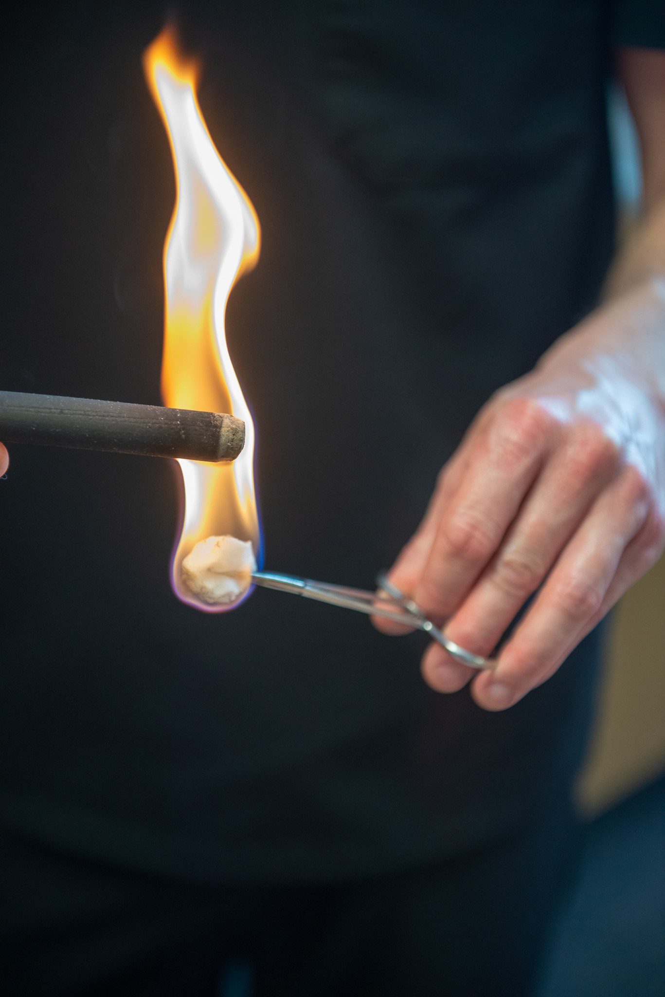 Moxibustion: Moxa stick being lit with cotton ball and flame