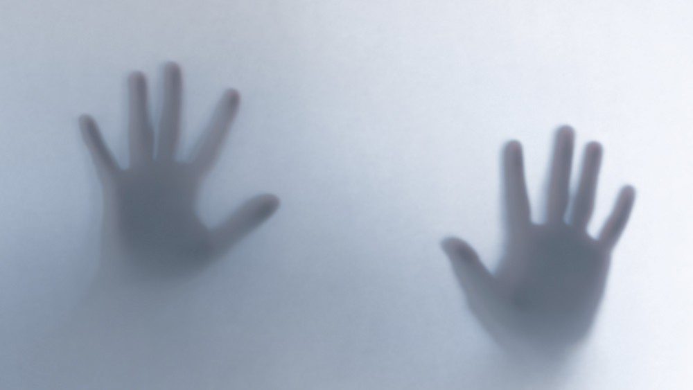 Hands on foggy glass
