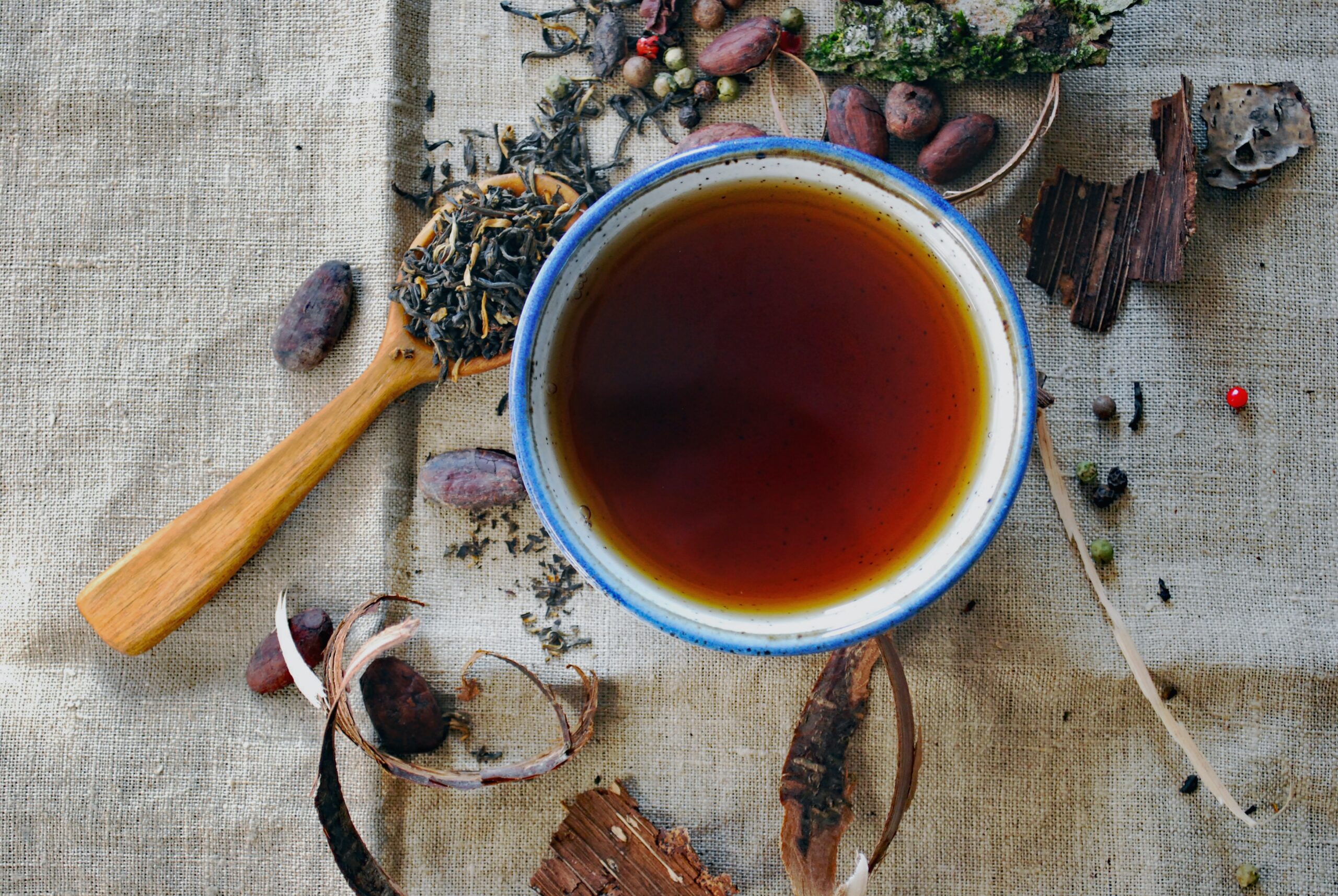 Cup of herbal tea against gray fabric