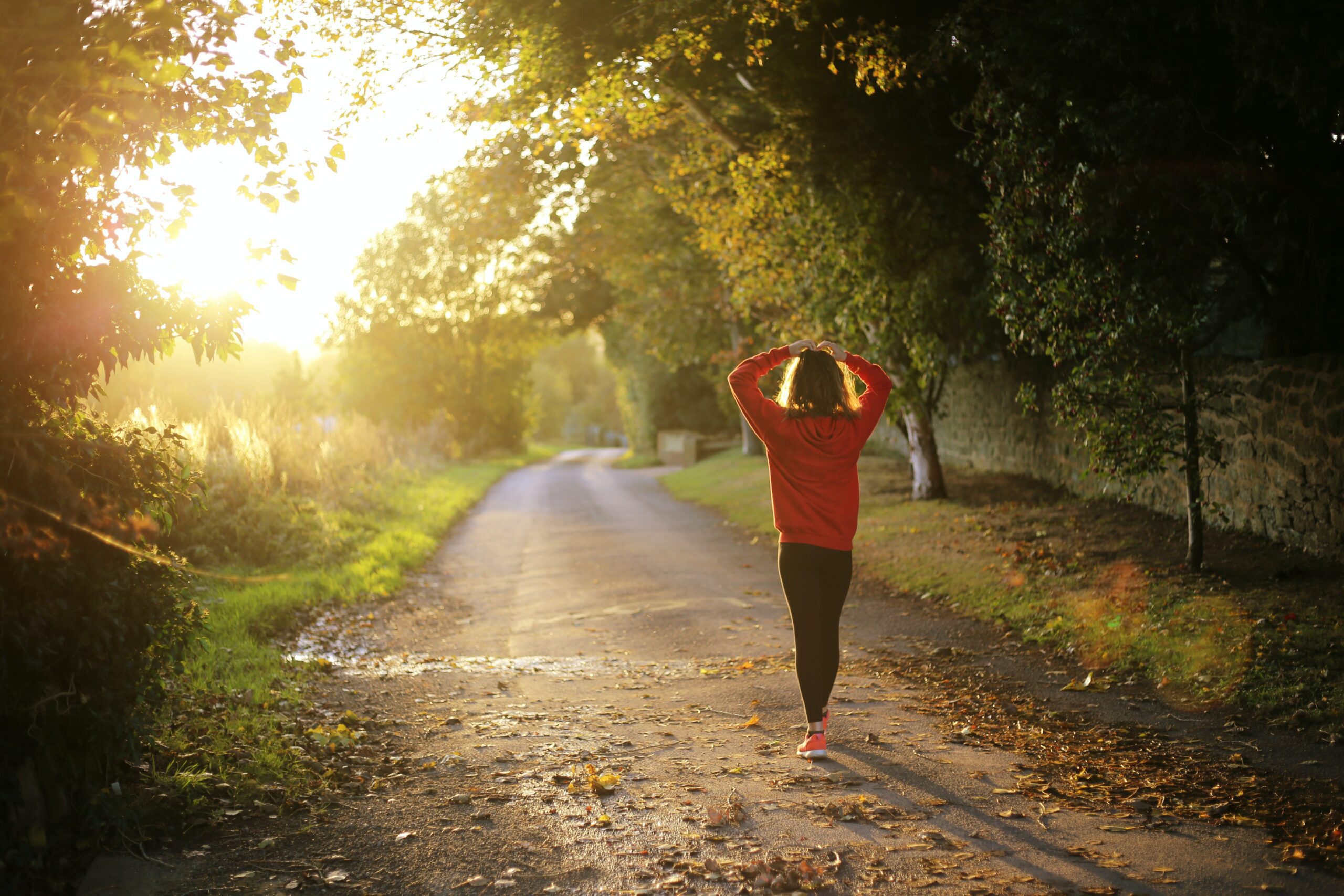 endocrine health: person walking down dirt road with hands on their head