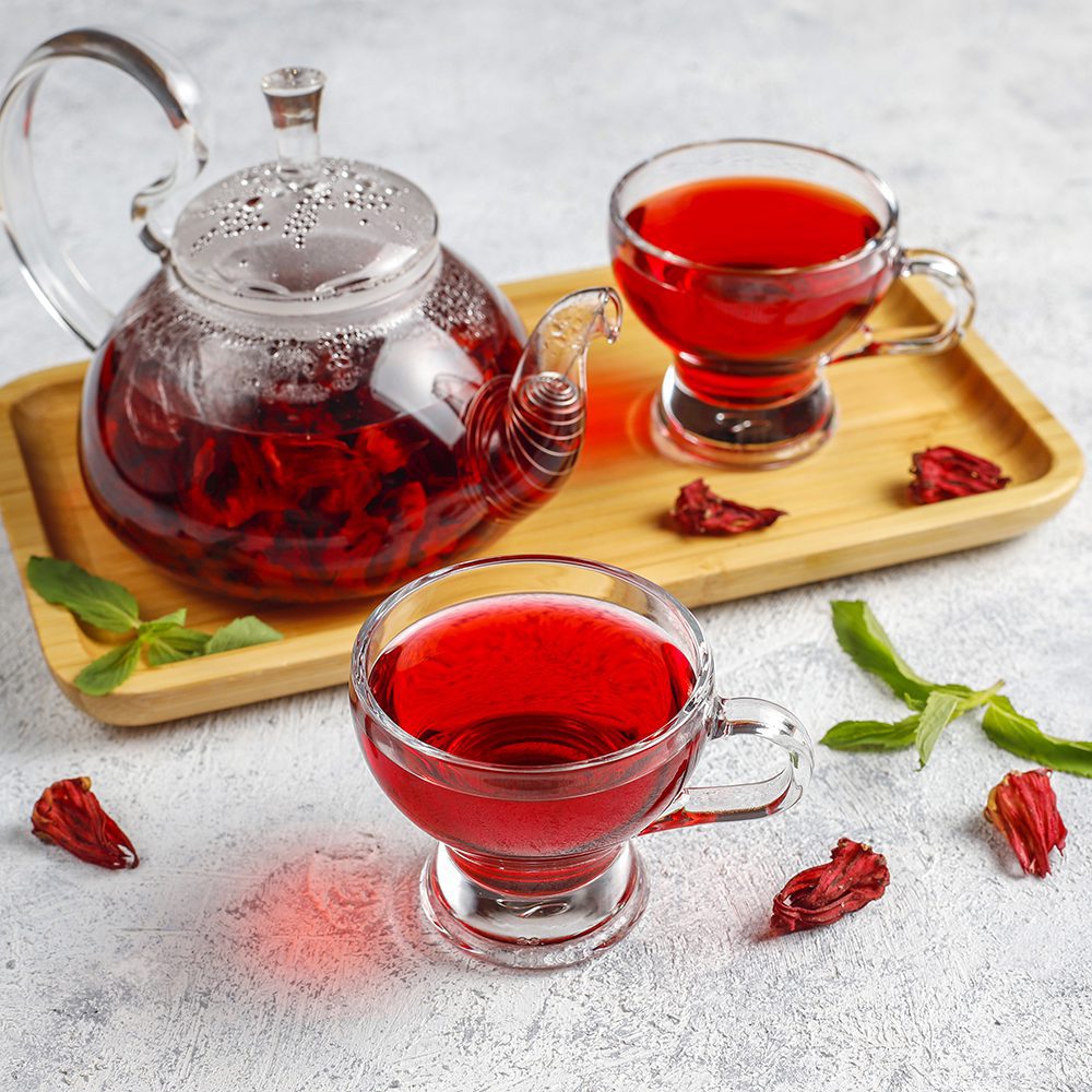 Hot Hibiscus tea in a glass mug and glass teapot.