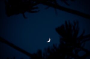 Nighttime sky with a crescent moon. Here is how to improve sleep