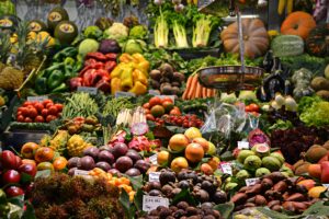 Abundance of fruit and vegetables. Included in this picture are pumpkins, tomatoes, dragon fruit, pineapples, peppers, and much more produce. Produce is 1 of the 6 natural ways to lower blood pressure