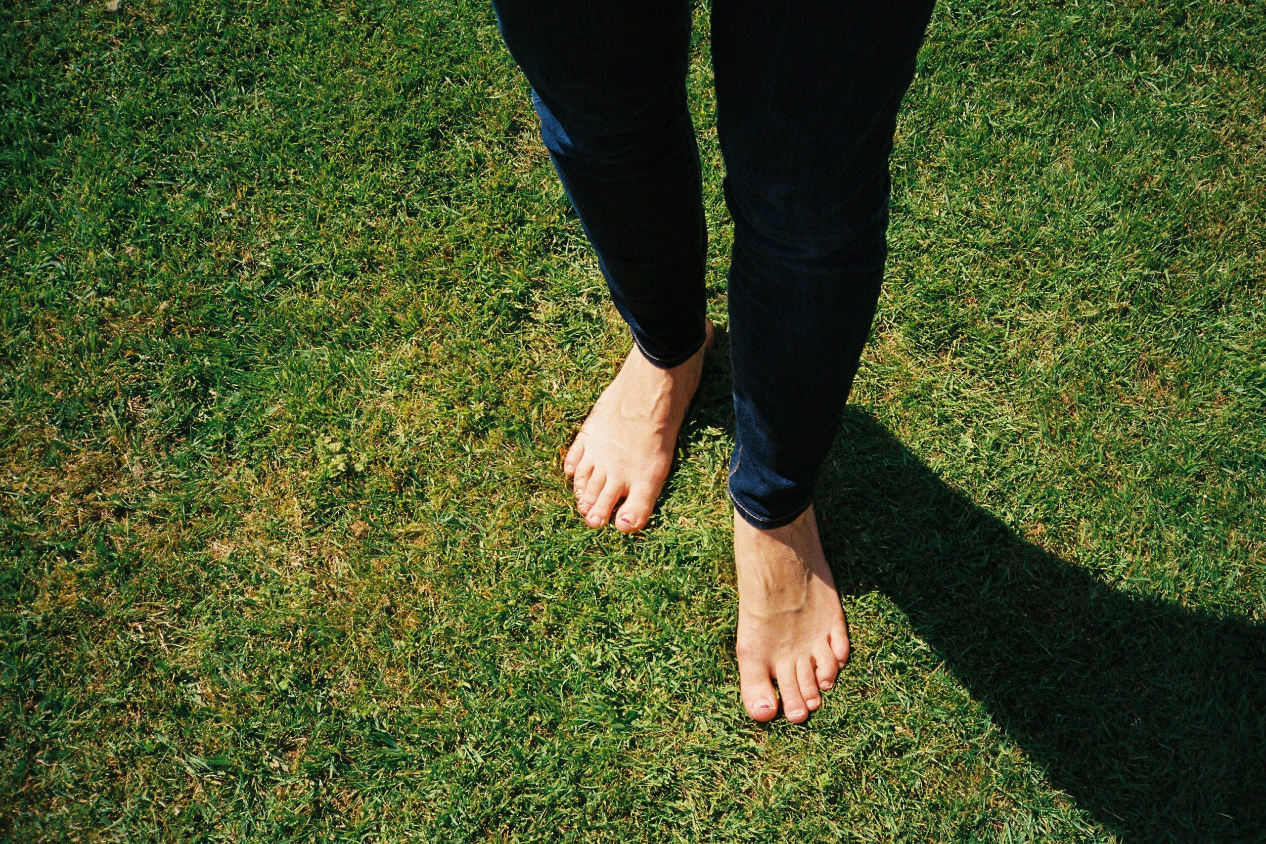 earthing barefoot on grass