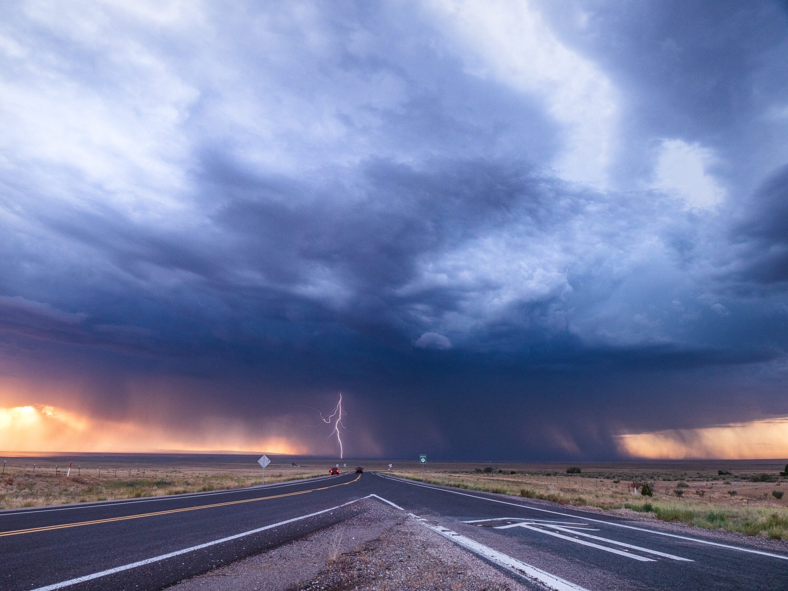 Lightning striking road in distance