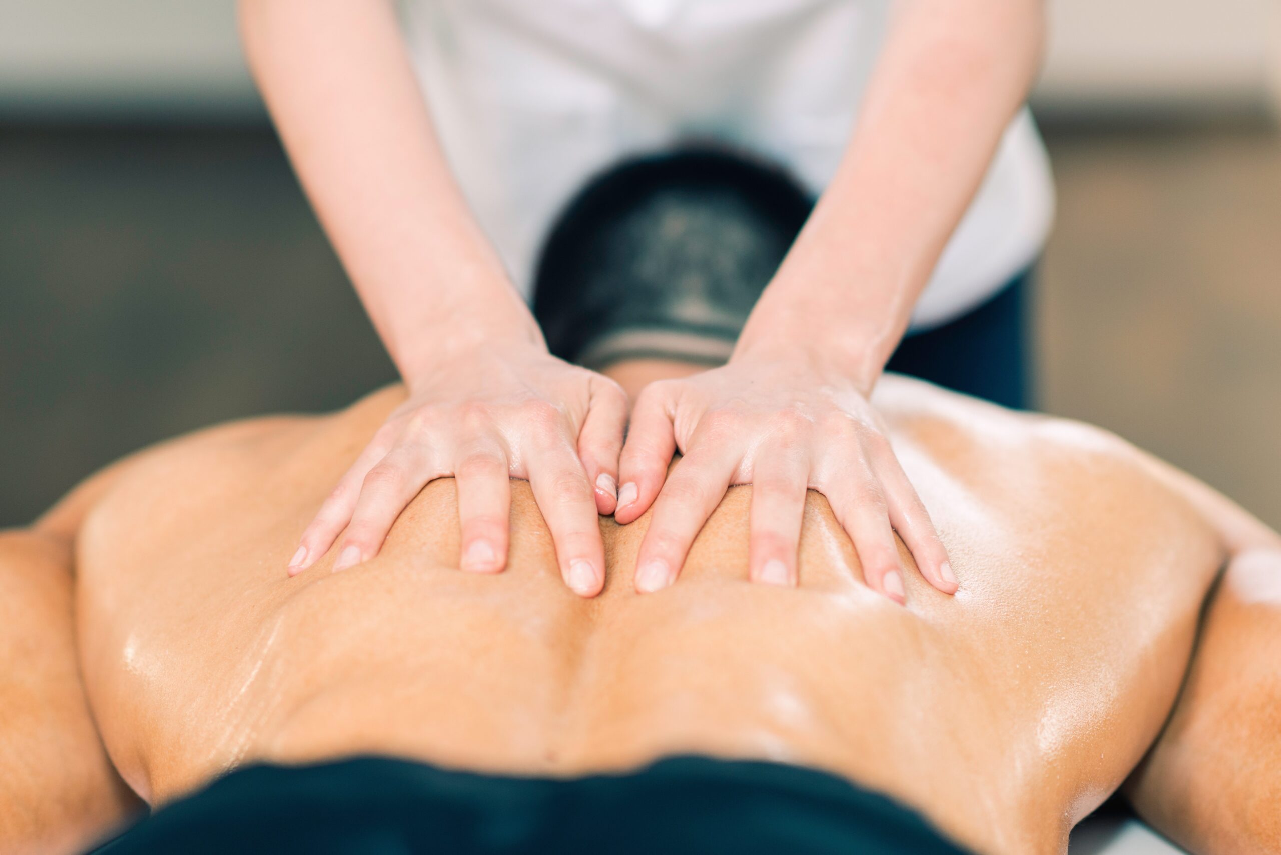 Sports massage. Therapist massaging athlete's back